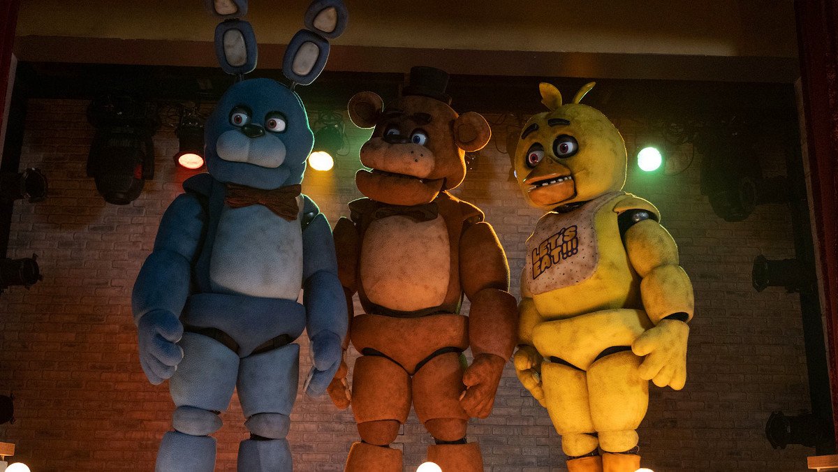 Three animatronics stand on a stage in Five Nights at Freddy's