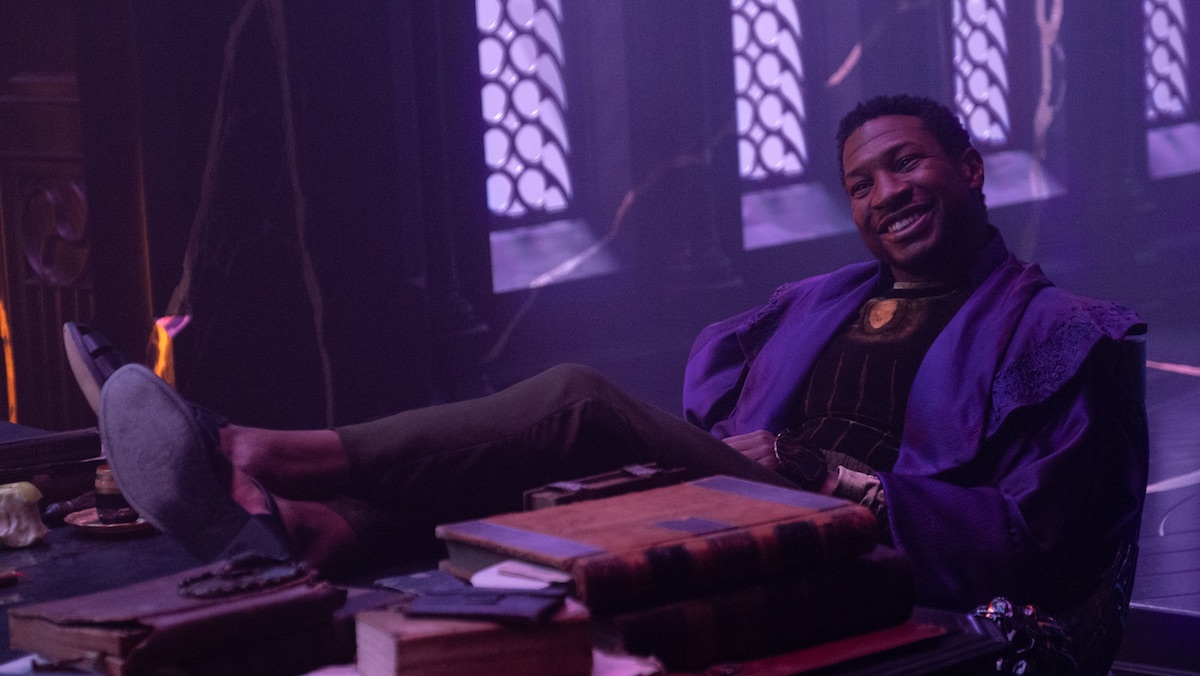 He Who Remains smiles with his feet on his desk at his office in the Citadel on Loki