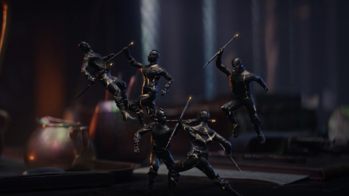 Miniatures fight each other on a desk in Loki