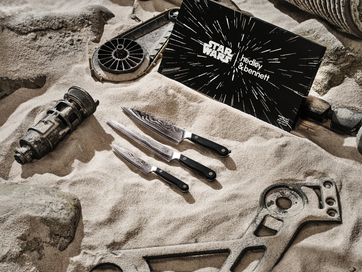 Three steel (beskar) knives on a background of sand in Hedley & Bennett's Star Wars collection